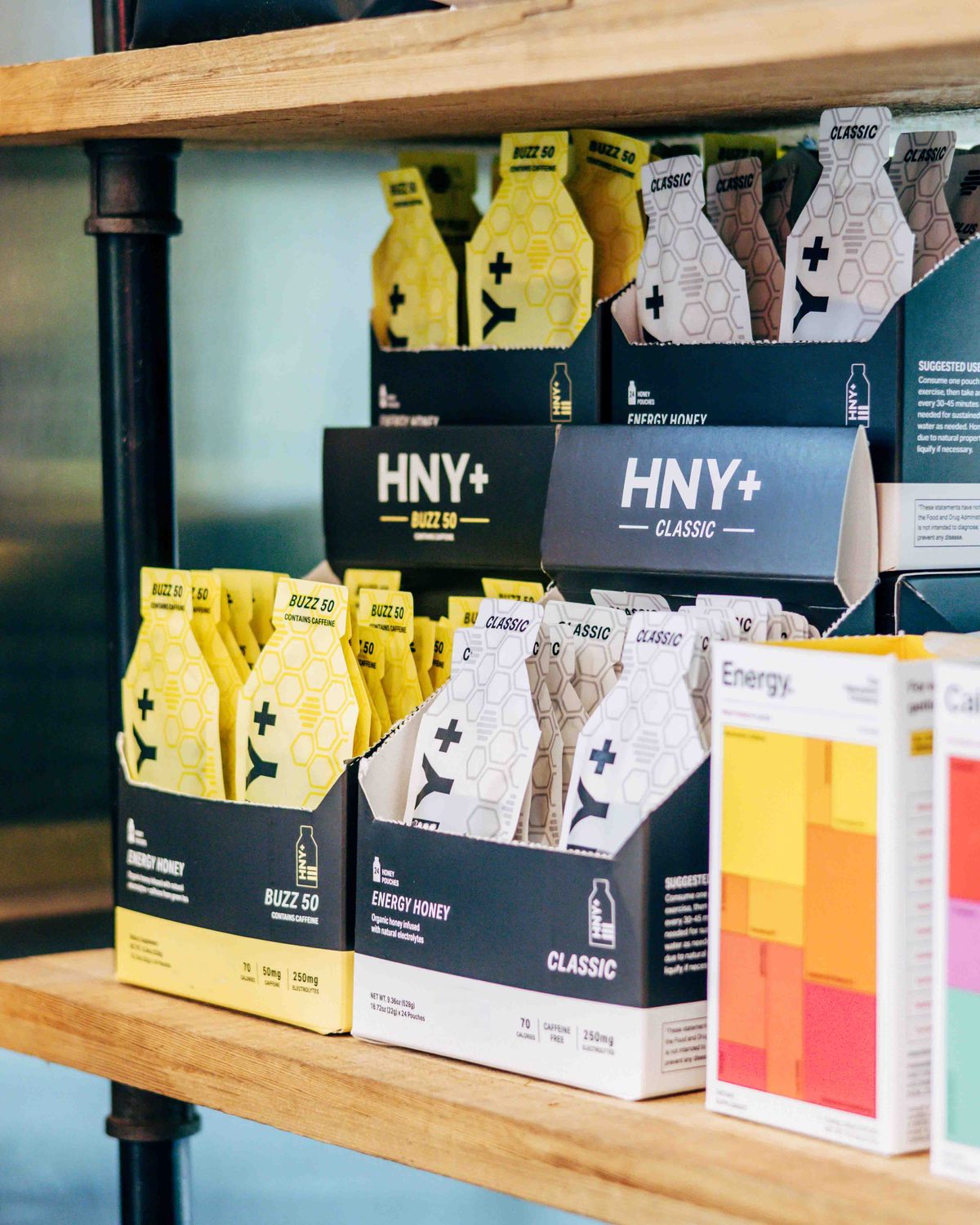 HNY+ energy honey gels on a retail shelf
